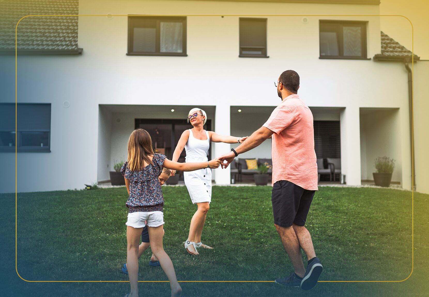 A man with short dark hair smiles and leans over to hug two kids while standing outside in the yard.