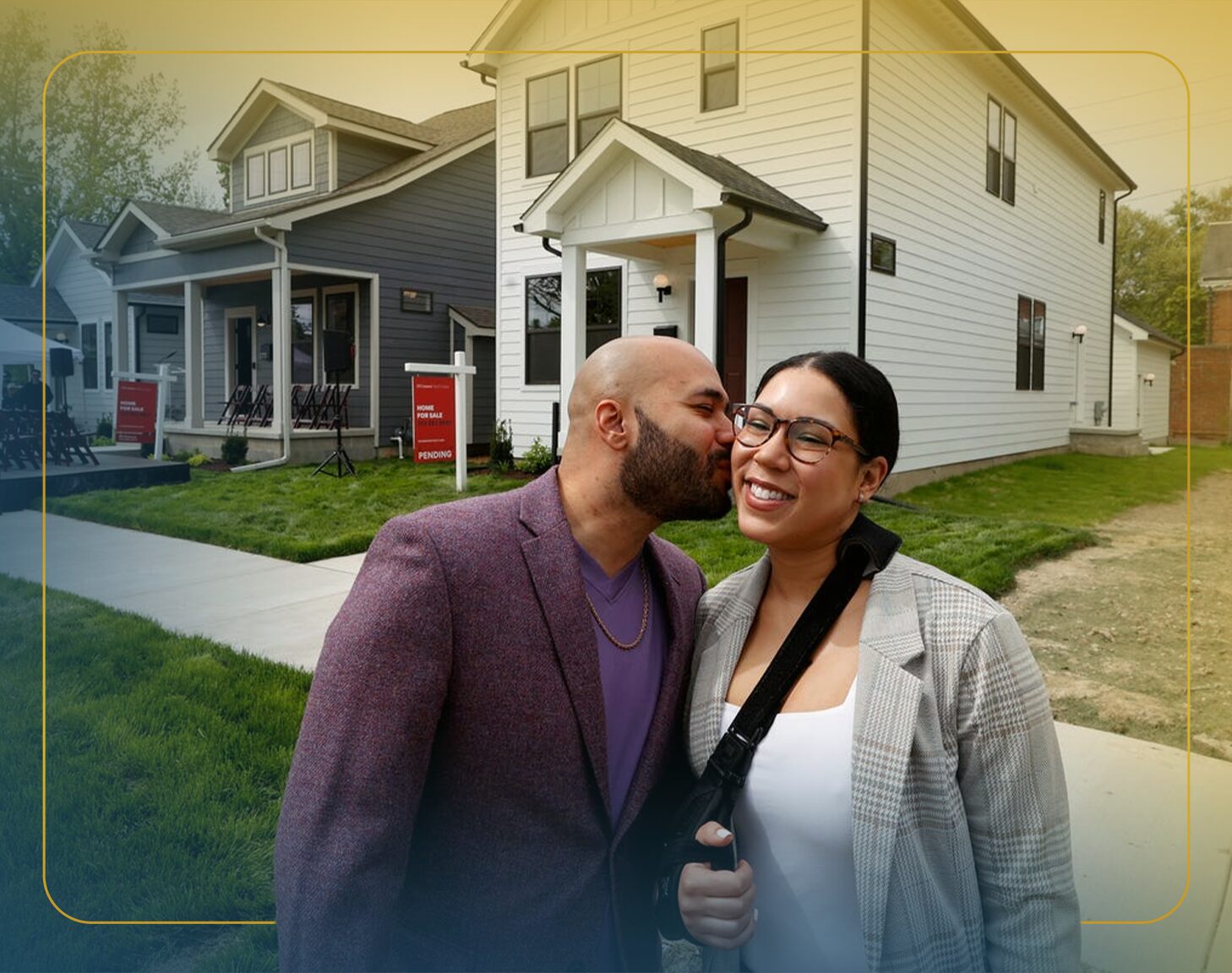 A white man with brown hair sits on the steps of his new home.