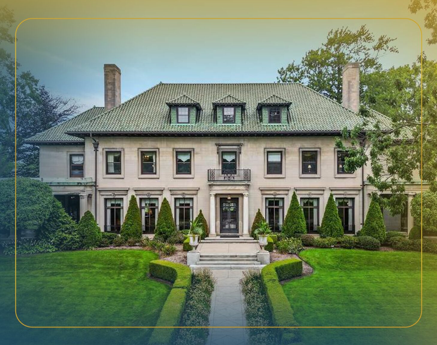 Two red chairs and a table on a dock overlook a lake, with a red cabin and large tree in the background.