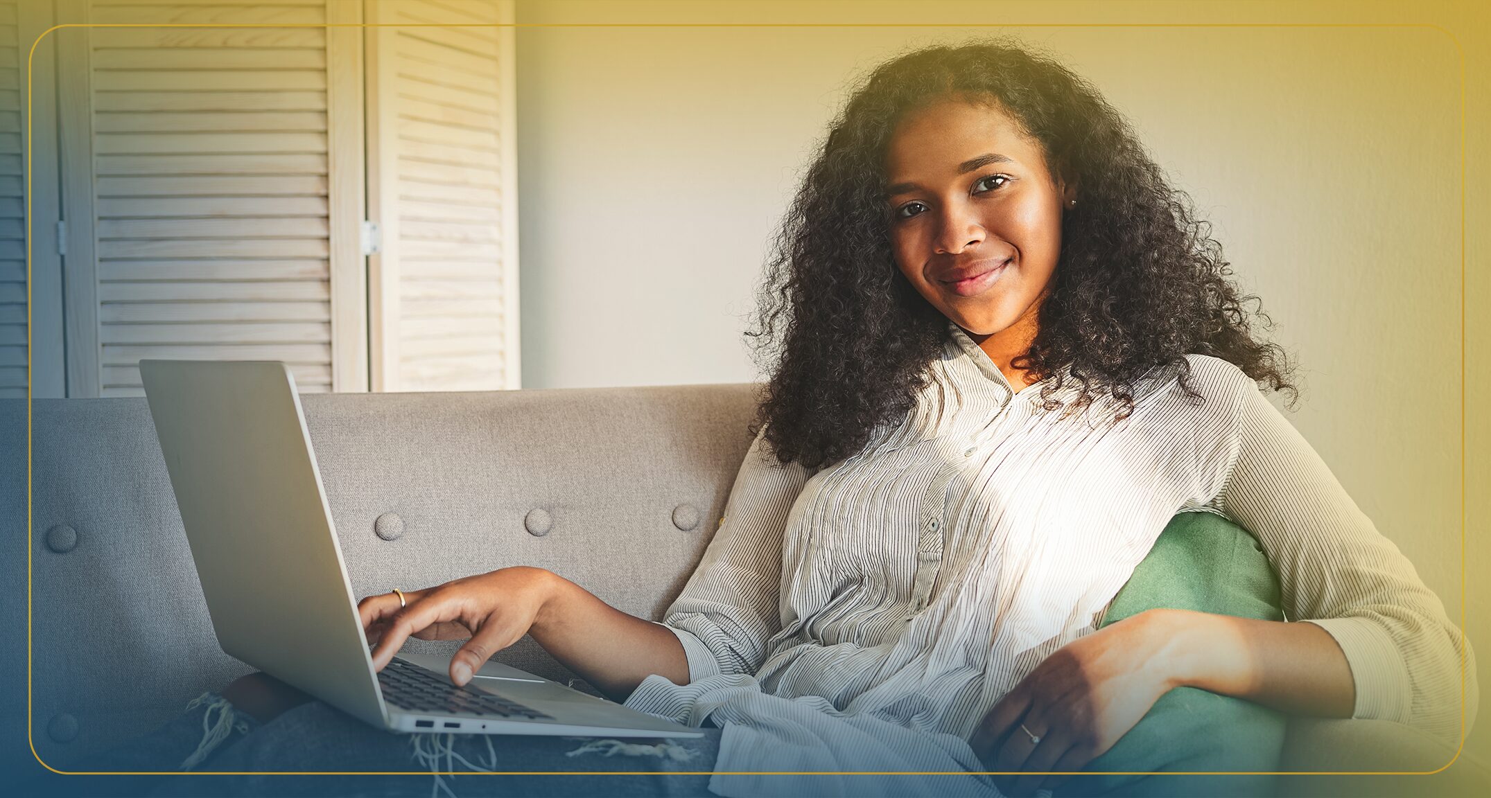 Black woman smiles while researching refinance options on her laptop.