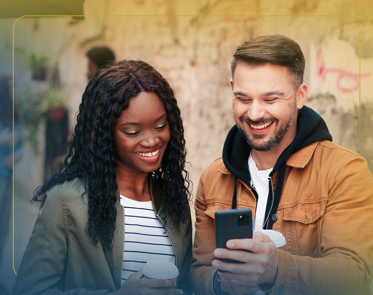 A woman walking with a group of people looks down at her phone.